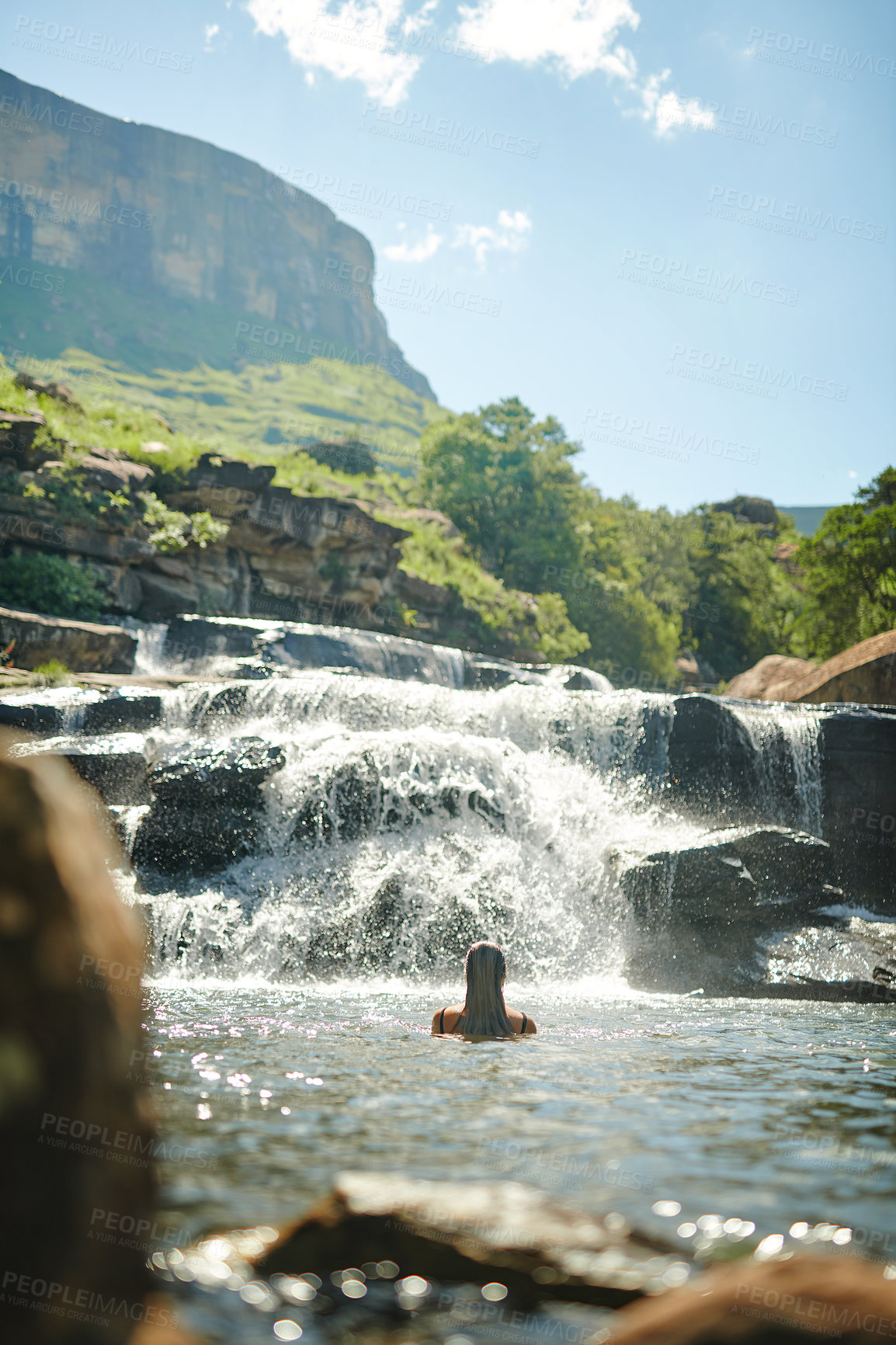 Buy stock photo Cropped shot of an unrecognizable woman swimming in a stream alone during a day outdoors