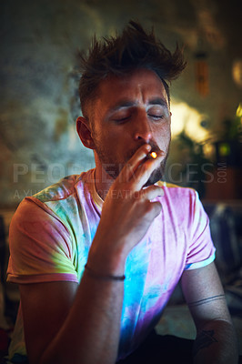 Buy stock photo Man, joint and smoke with weed in home for marijuana habit, narcotics and drugs at night. Male person, cannabis and cigarette with puff for hemp, 420 and medical CBD for chill, relax or stress relief