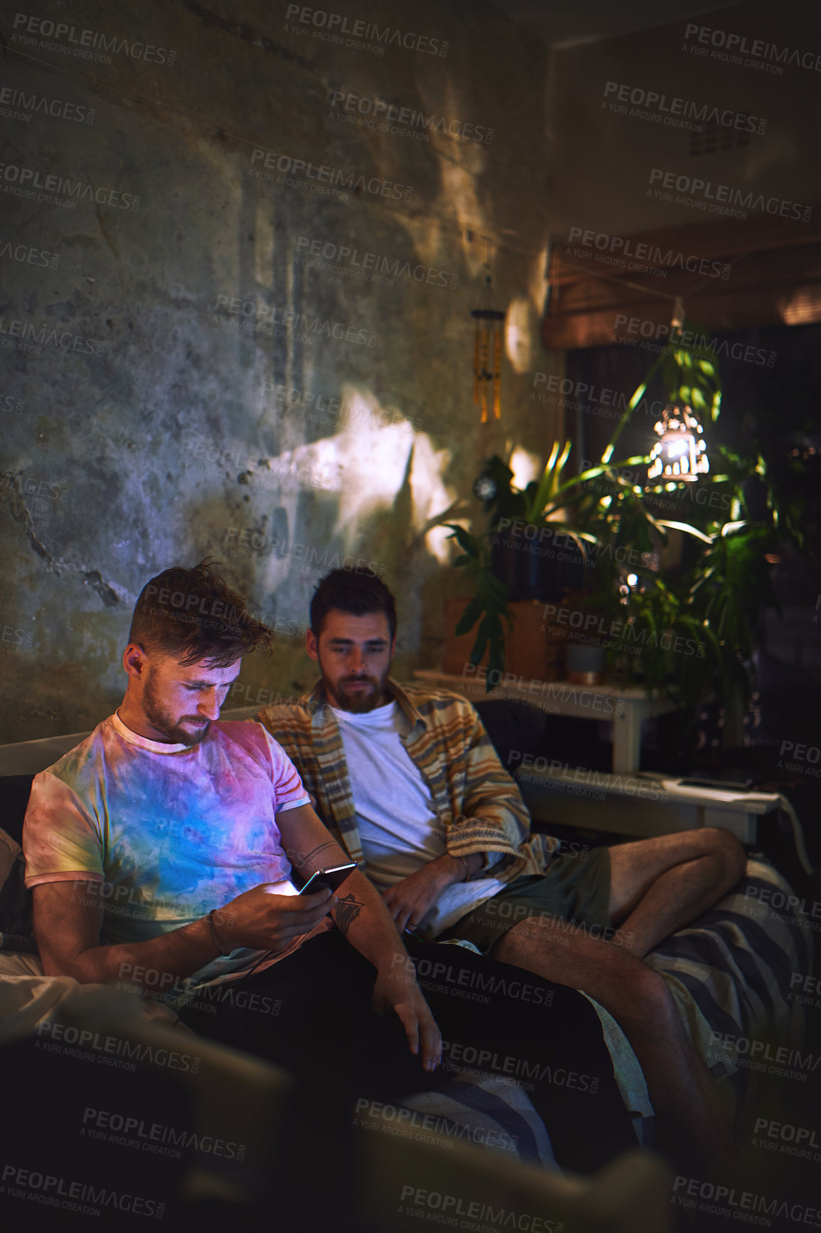 Buy stock photo Night, couch and guy friends with smartphone checking social media, video and relax together in home. Weekend, hangout and men with phone, online search or streaming app on sofa in dark living room