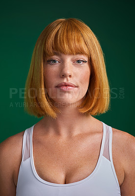 Buy stock photo Cropped portrait of an attractive young sportswoman standing alone against a green background in the studio