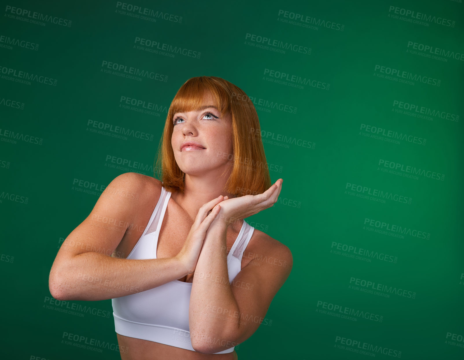 Buy stock photo Cropped shot of an attractive young sportswoman standing alone and posing against a green background in the studio