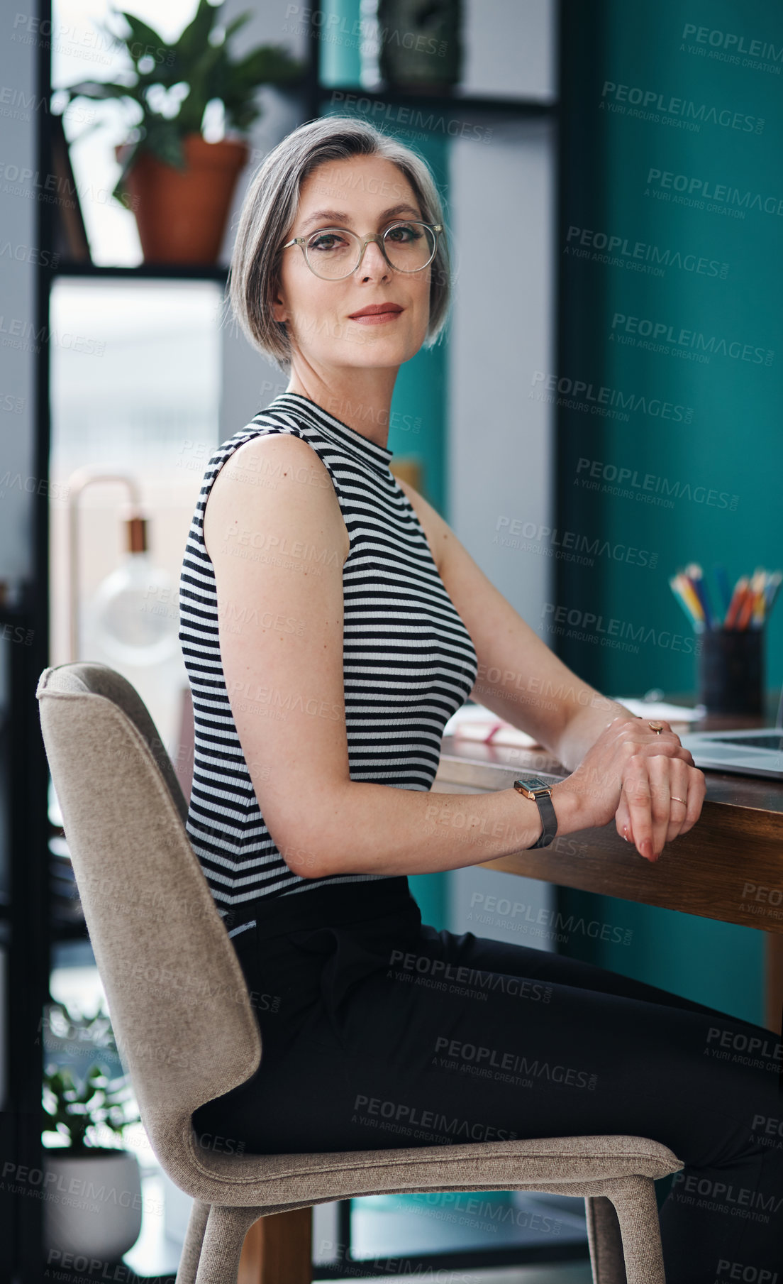 Buy stock photo Cropped shot of a mature businesswoman sitting in a modern office