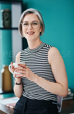 Buy stock photo Shot of a mature businesswoman having coffee in her office