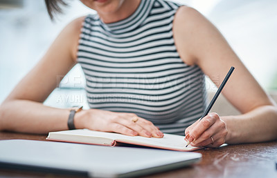 Buy stock photo Shot of an unrecognizable businesswoman writing in her notebook