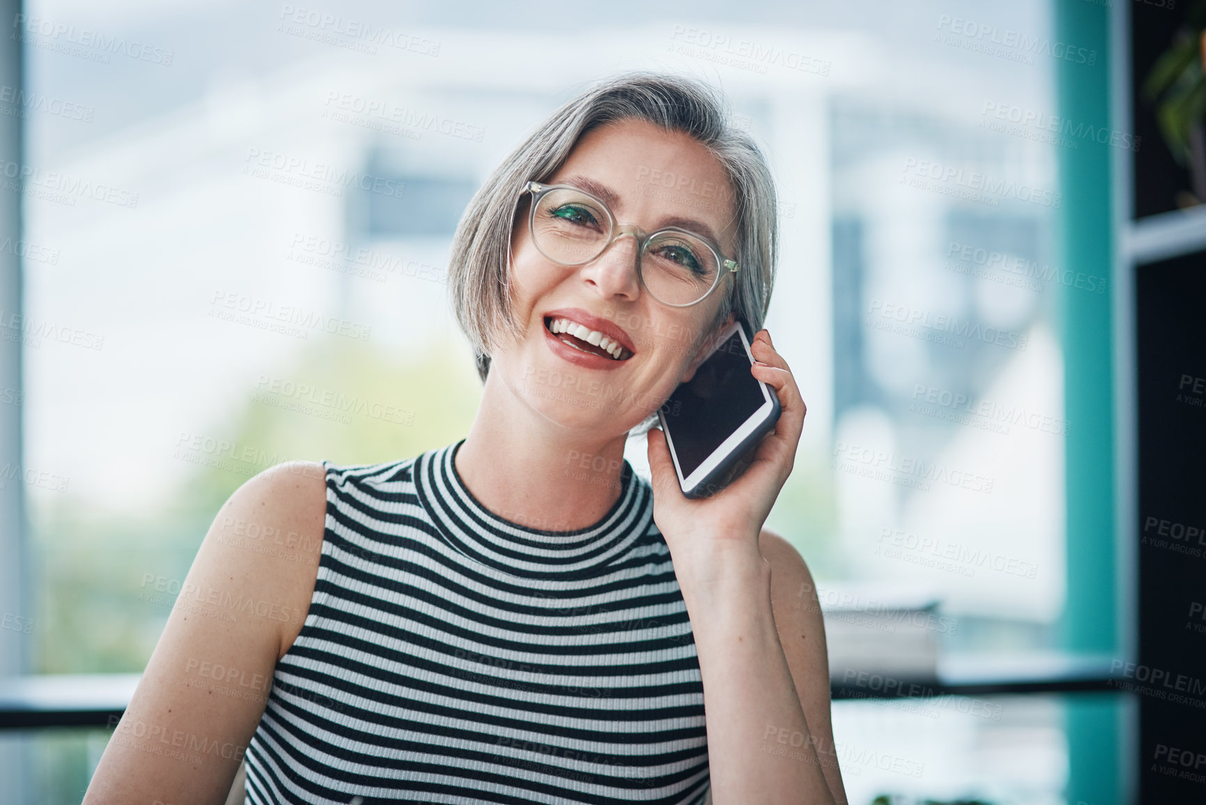 Buy stock photo Cropped shot of a mature businesswoman talking on her cellphone