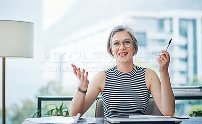 Buy stock photo Cropped shot of a mature businesswoman sitting at her desk