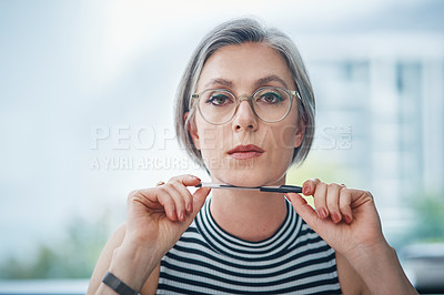 Buy stock photo Cropped shot of a mature businesswoman sitting at her desk
