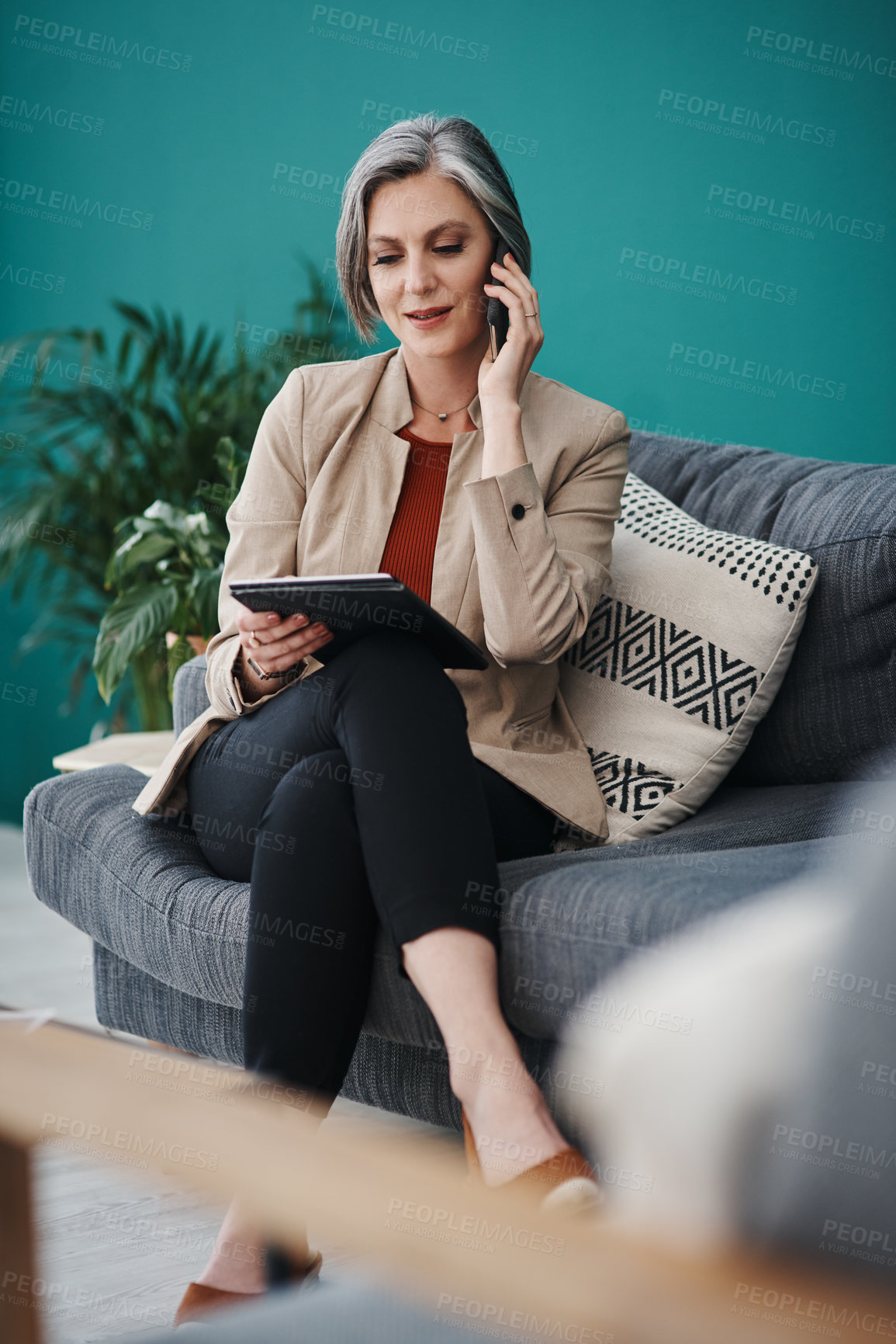 Buy stock photo Cropped shot of an attractive mature businesswoman sitting alone and using technology in her home office