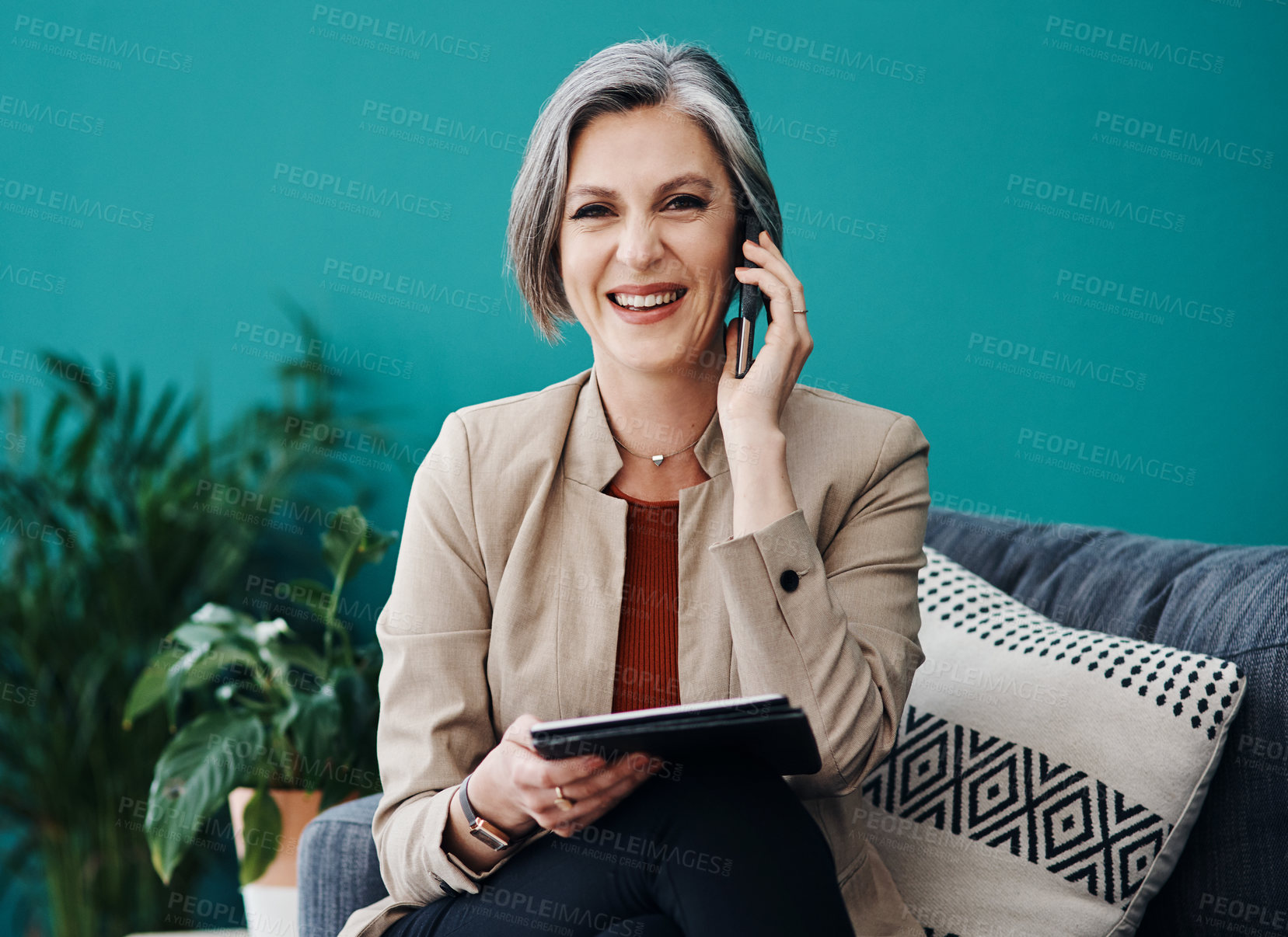 Buy stock photo Cropped portrait of an attractive mature businesswoman sitting alone and using technology in her home office