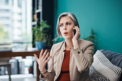 Buy stock photo Cropped shot of an attractive mature businesswoman sitting alone and talking on her cellphone in her home office