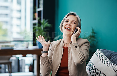 Buy stock photo Cropped portrait of an attractive mature businesswoman sitting alone and talking on her cellphone in her home office