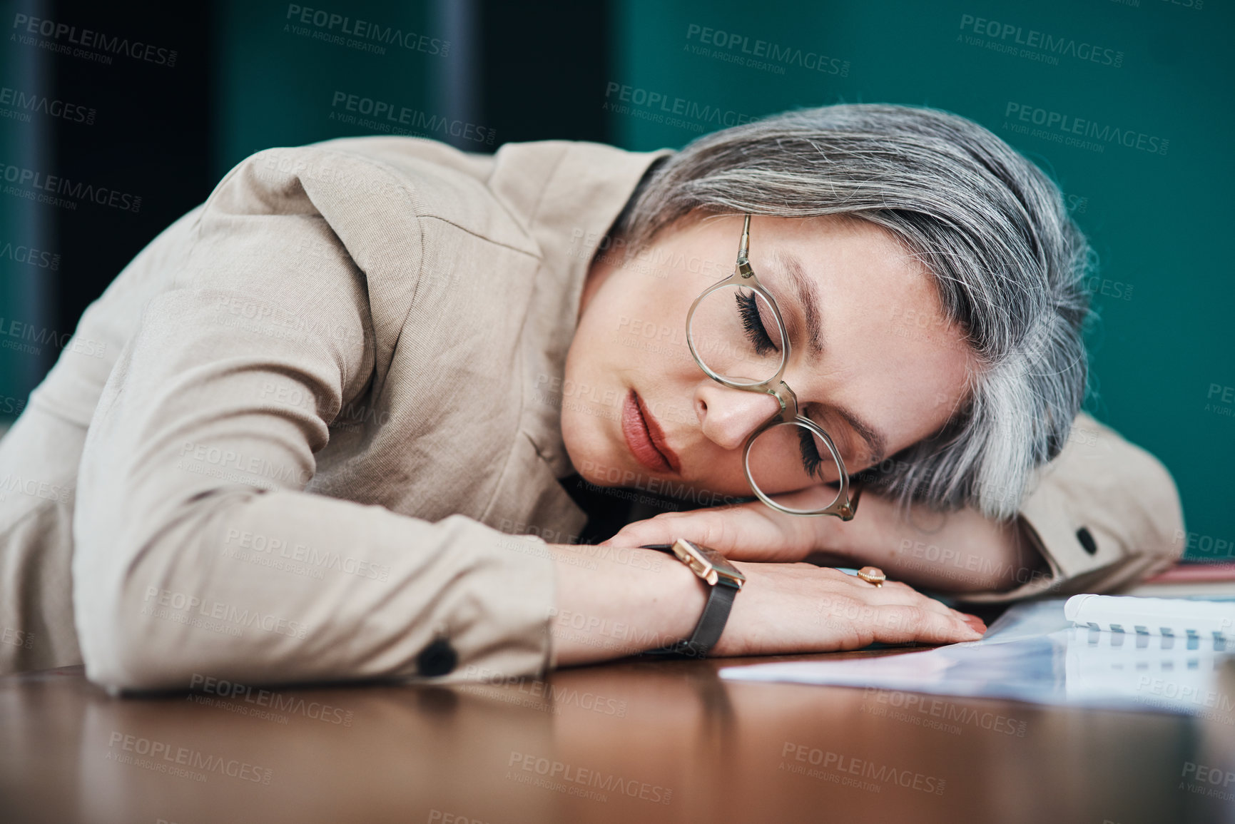 Buy stock photo Cropped shot of an attractive mature businesswoman asleep at her desk in her home office