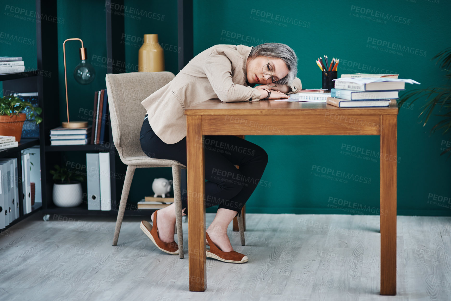 Buy stock photo Full length shot of an attractive mature businesswoman asleep at her desk in her home office
