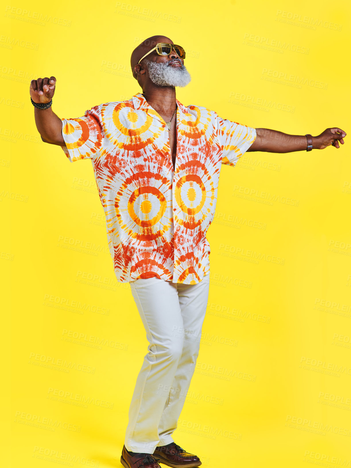 Buy stock photo Full length shot of a funky and stylish senior man dancing in studio against a yellow background