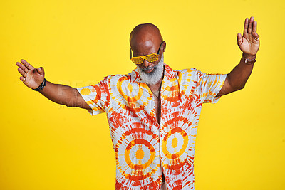 Buy stock photo Cropped shot of a funky and stylish senior man dancing in studio against a yellow background