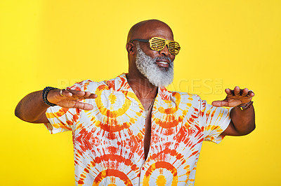 Buy stock photo Cropped shot of a funky and stylish senior man dancing in studio against a yellow background