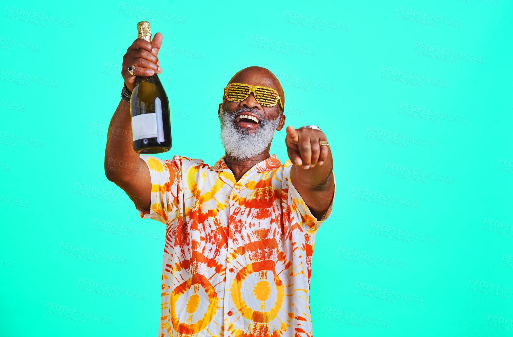 Buy stock photo Cropped shot of a funky and cheerful senior man celebrating and drinking champagne in studio against a turquoise background