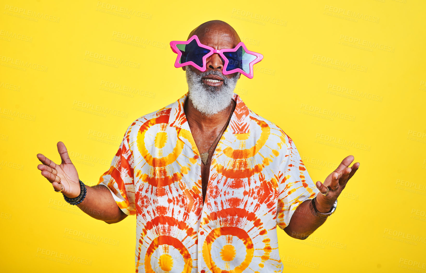 Buy stock photo Portrait of a funky and stylish senior man wearing sunglasses posing in studio against a yellow background