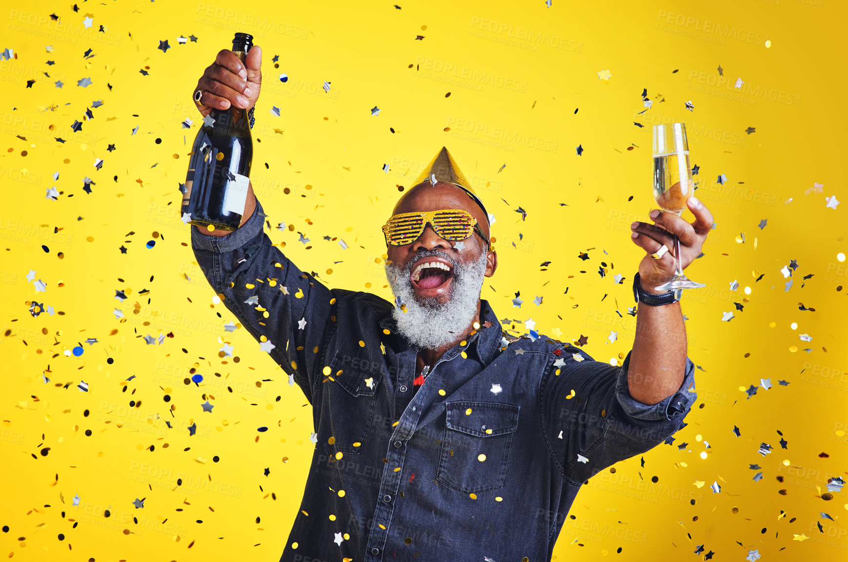Buy stock photo Portrait of a cheerful senior man celebrating and drinking champagne in studio against a yellow background