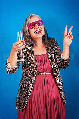 Buy stock photo Portrait of a funky and cheerful senior woman drinking a glass of champagne in studio
