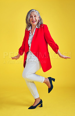 Buy stock photo Full length shot of a funky and stylish senior woman posing in studio against a yellow background