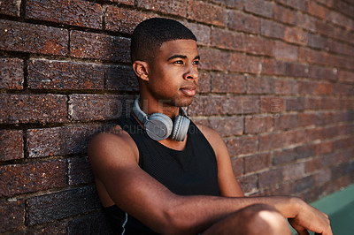 Buy stock photo Man, outdoor and thinking for fitness, training or wellness on basketball court as athlete. Male person, headphones and music on campus for competition, exercise and game with planning or streaming