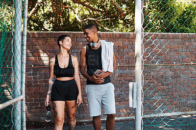 Buy stock photo Walking, fitness and talking with interracial couple on court for sports training, health and teamwork. Workout, personal trainer and exercise with man and woman for wellness, summer and performance