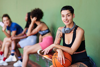 Buy stock photo Portrait of a sporty young woman taking a break with her friends after a game of basketball