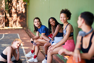 Buy stock photo Shot of a group of sporty young women chatting to each other on a sports court