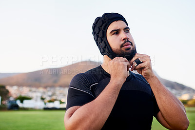 Buy stock photo Man, sport and adjusting headgear for rugby, game or competition in exercise, wellness or fitness. Male person, athlete and recreation facility in scrum cap for match, outdoor and training in stadium