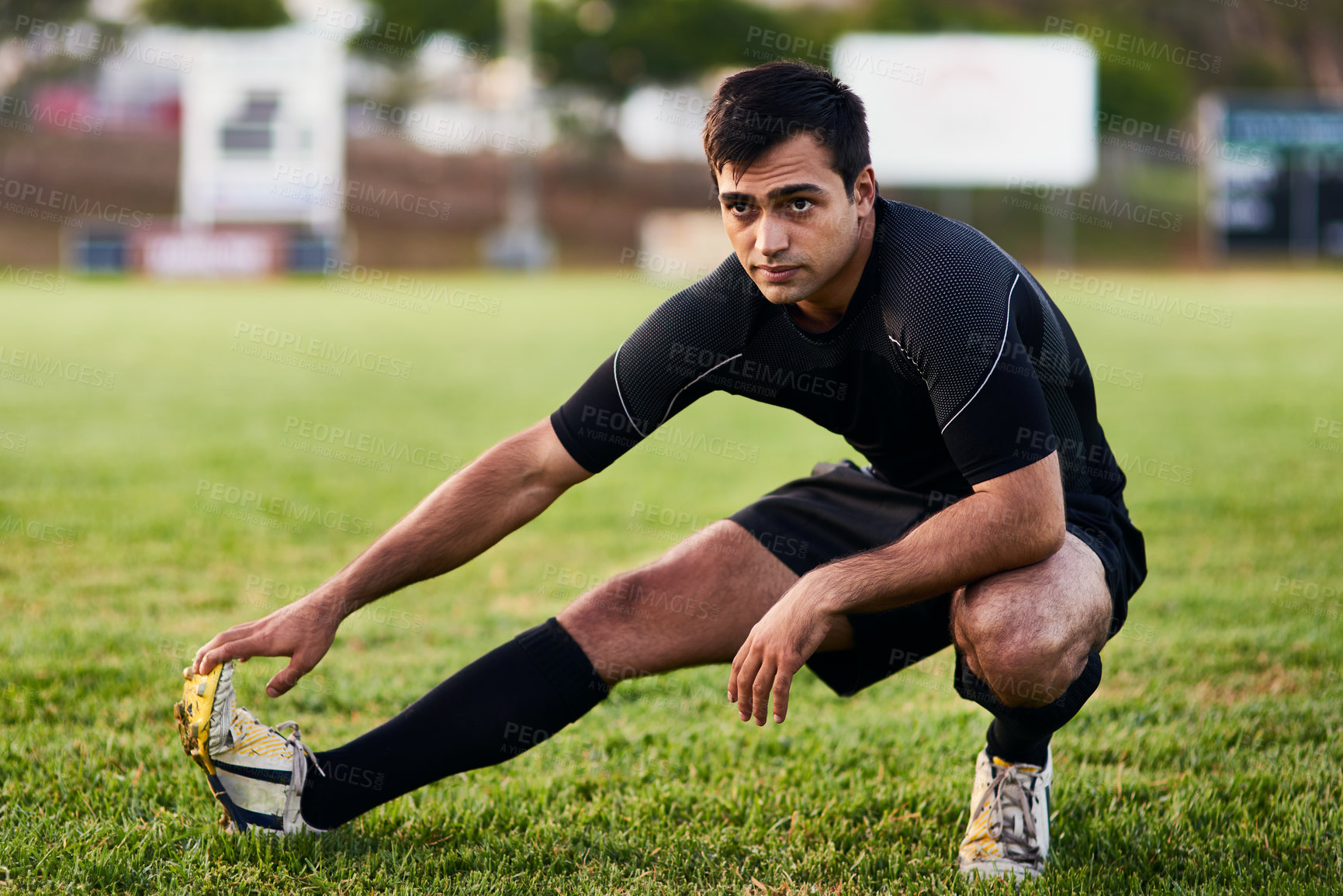 Buy stock photo Sport, rugby and man stretching for fitness on grass field with match warm up, game workout and performance. Athlete, player and leg exercise for competition preparation and practice for tournament