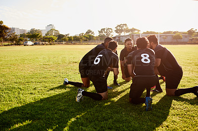 Buy stock photo Full length shot of a diverse group of sportsmen crouching together before playing rugby during the day