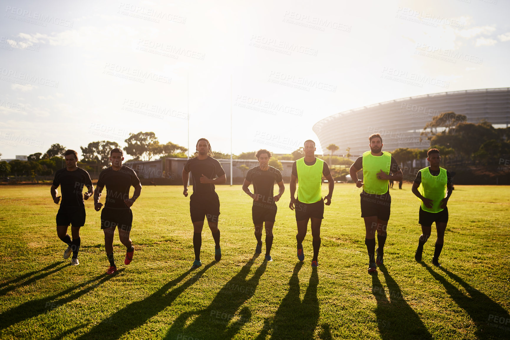 Buy stock photo Sports, group and men with warm up for rugby, competition game and practice with training for tournament. Stadium, people and players with running for fitness, endurance and team for match in France