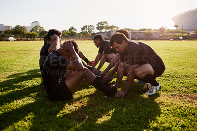 Buy stock photo Full length shot of a diverse group of sportsmen training during a rugby practice in a sports club