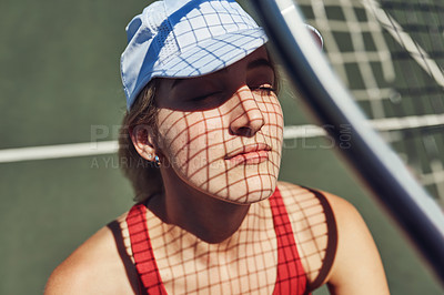 Buy stock photo Cropped shot of an attractive young sportswoman standing alone and posing on a tennis court during the day