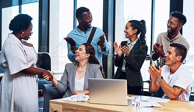 Buy stock photo Shot of a group of businesspeople applauding their colleagues in an office