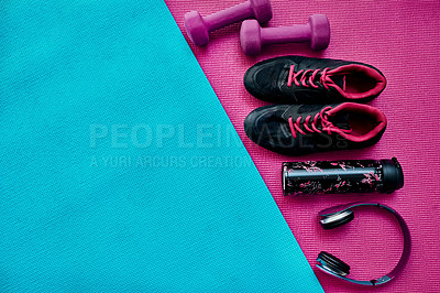 Buy stock photo High angle shot of a group of workout essentials lying on top of a colourful background  inside of a studio