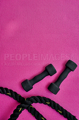 Buy stock photo Training, exercise and rope with dumbbell in studio for strength workout, endurance and routine. Top view, weights and pink background with mockup space for bodybuilding fitness, health and wellness