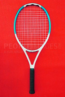 Buy stock photo High angle shot of a single tennis racket placed on a red background inside of a studio