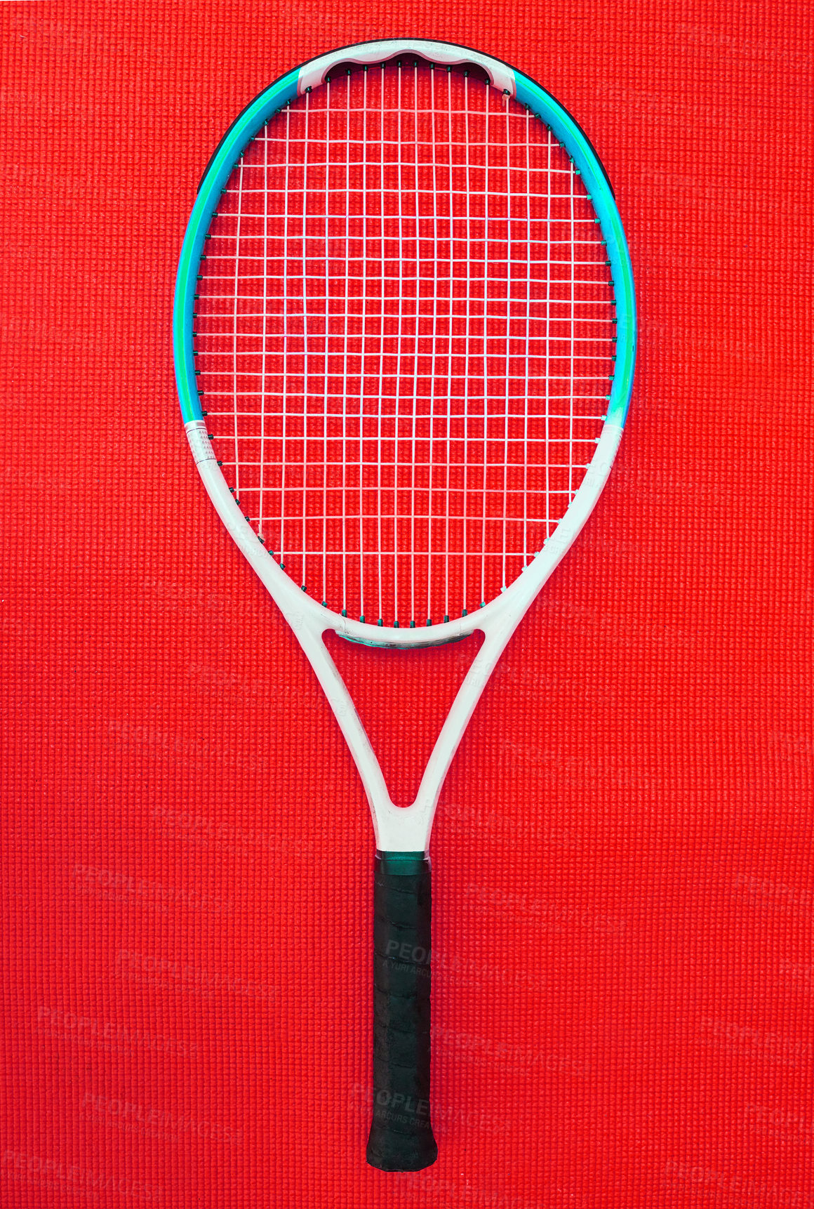Buy stock photo High angle shot of a single tennis racket placed on a red background inside of a studio