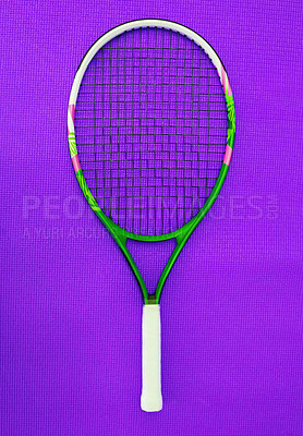 Buy stock photo High angle shot of a single tennis racket placed on a purple background inside of a studio