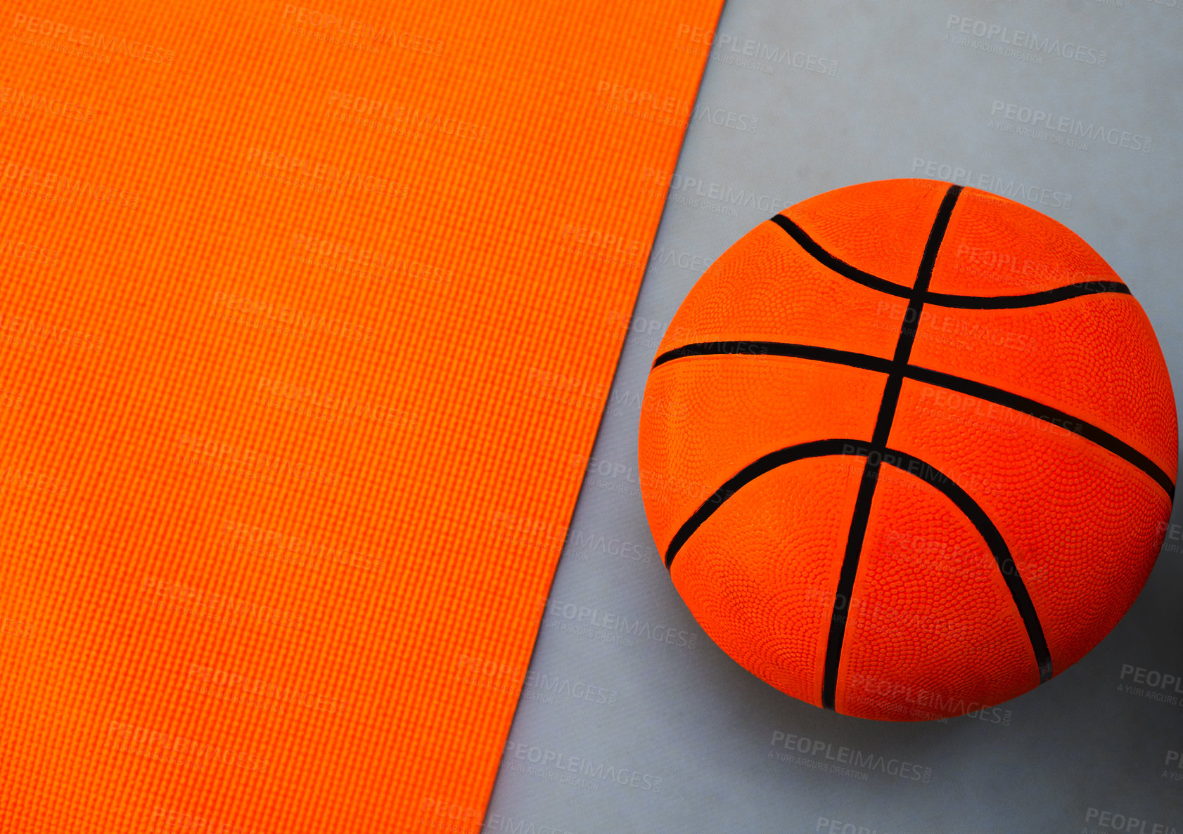 Buy stock photo High angle shot of a single basket ball placed on top of a colourful background inside of a studio