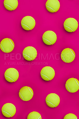 Buy stock photo High angle shot of a group of tennis balls placed together in formation on top of a pink background inside of a studio
