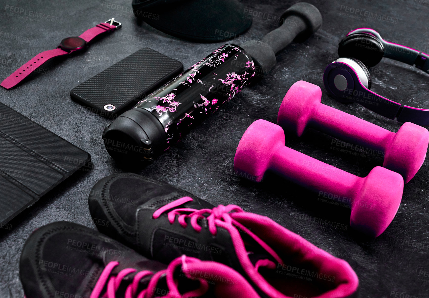 Buy stock photo High angle shot of a group of workout essentials lying on top of a dark background  inside of a studio