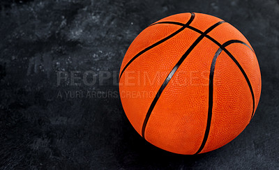 Buy stock photo High angle shot of a single basket ball placed on top of a dark background inside of a studio