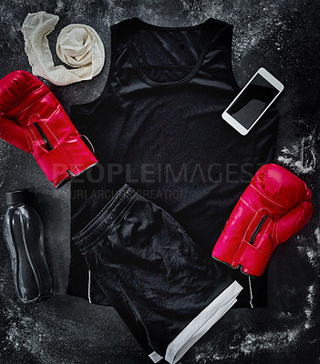 Buy stock photo High angle shot of boxing essentials placed on top of a dark background inside of a studio