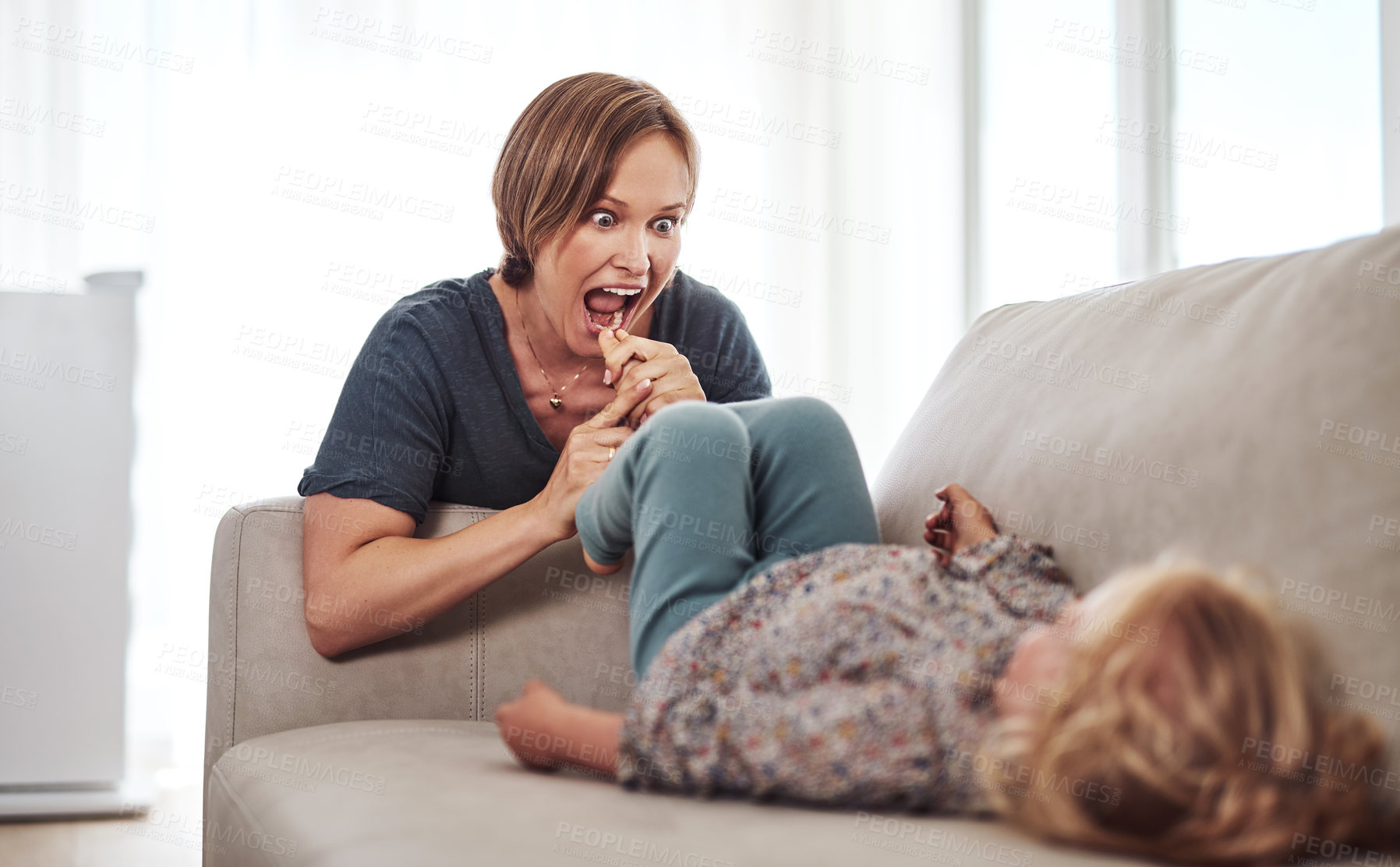 Buy stock photo Cropped shot of an attractive young mother and playing with her daughter in the living room at home