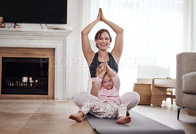 Buy stock photo Full length portrait of an adorable little girl feeling playful while her mother does yoga in the living room