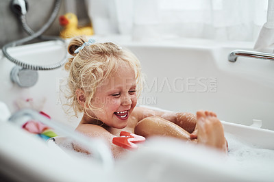 Buy stock photo Cropped shot of an adorable little girl taking a bubble bath during her morning routine at home