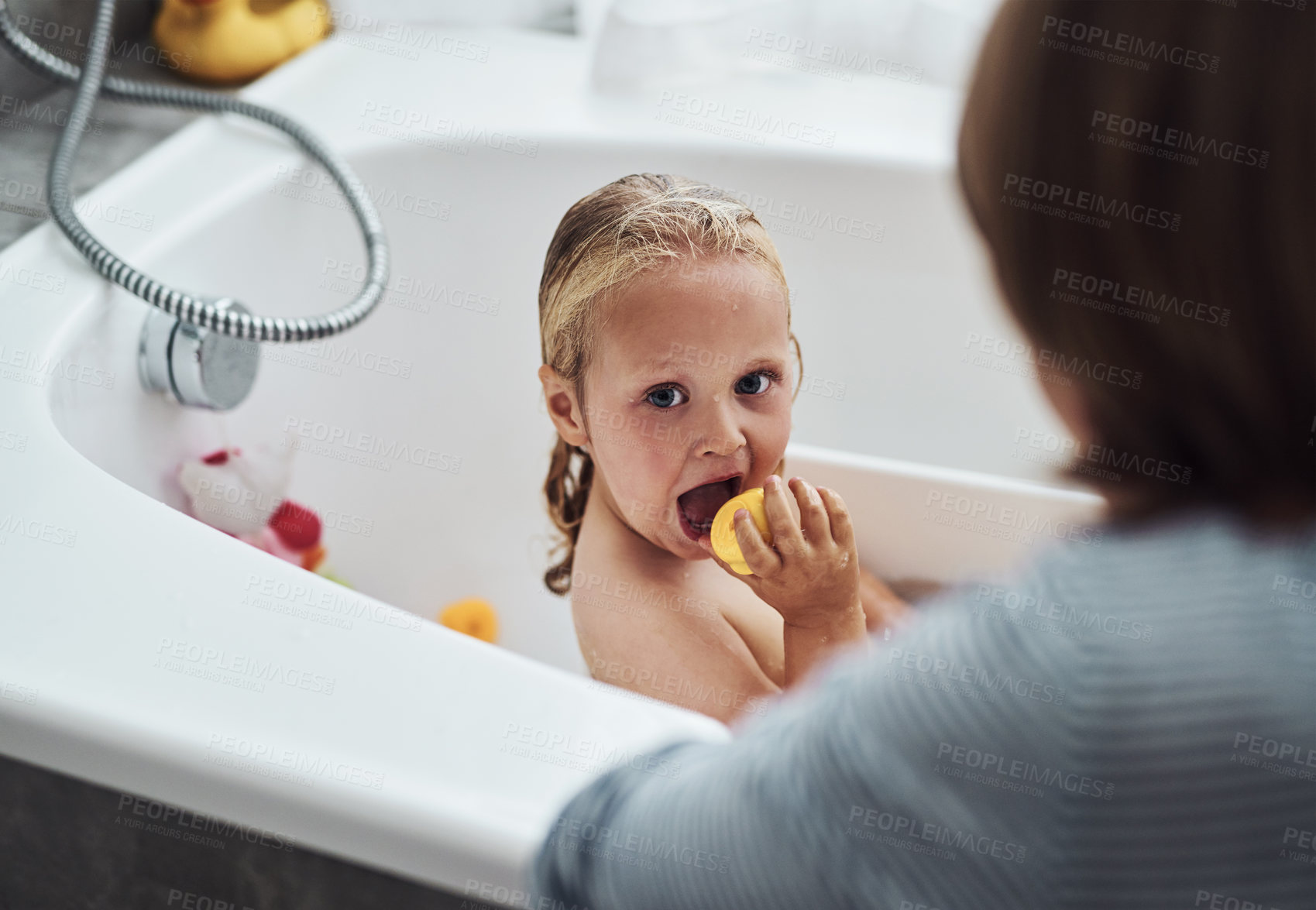Buy stock photo Cropped shot of an adorable little girl bonding with her mother while taking a bath at home